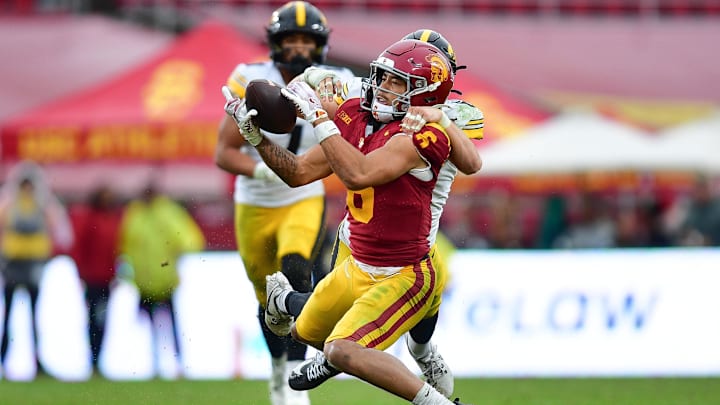 Nov 15, 2025; Los Angeles, California, USA; Southern California Trojans wide receiver Makai Lemon (6) catches a pass against the defense of Iowa Hawkeyes defensive back Zach Lutmer (6) during the second half at the Los Angeles Memorial Coliseum. Mandatory Credit: Gary A. Vasquez-Imagn Images