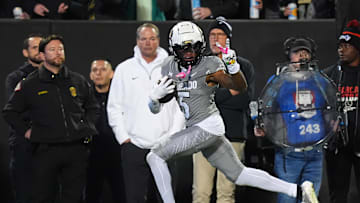 Oct 26, 2024; Boulder, Colorado, USA; Colorado Buffaloes wide receiver Jimmy Horn Jr. (5) signals a peace sign to Cincinnati Bearcats defensive back Josh Minkins (0) and is called for taunting penalty in the first quarter at Folsom Field. Mandatory Credit: Ron Chenoy-Imagn Images