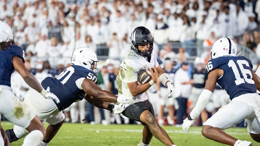 Oregon quarterback Dante Moore carries the ball against Penn State.