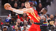 Dec 5, 2025; Atlanta, Georgia, USA; Atlanta Hawks center Kristaps Porzingis (8) is defended by Denver Nuggets guard Tim Hardaway Jr. (10) in the third quarter at State Farm Arena. Mandatory Credit: Brett Davis-Imagn Images