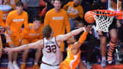 Dec 14, 2024; Champaign, Illinois, USA;  Tennessee Volunteers guard Jordan Gainey (11) drives to the basket and scores as Illinois Fighting Illini guard Kasparas Jakucionis (32) defends in the final seconds at State Farm Center. Mandatory Credit: Ron Johnson-Imagn Images