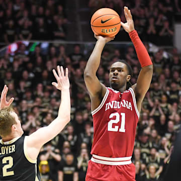 Indiana Hoosiers forward Mackenzie Mgbako (21) makes a three-point basket over Purdue Boilermakers guard Fletcher Loyer (2) during the first half at Mackey Arena.