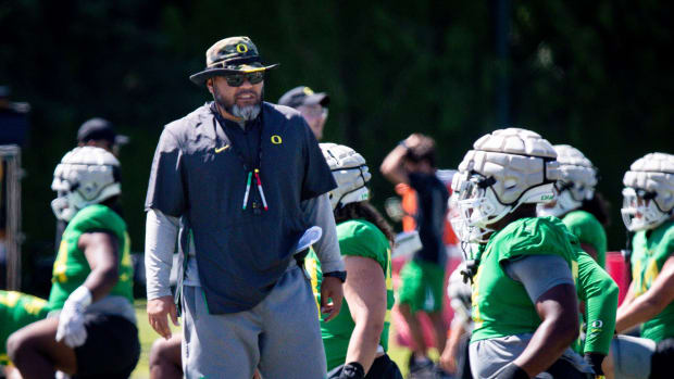 Oregon defensive line coach Tony Tuioti walks the field during practice with the Ducks Wednesday, Aug. 9, 2023 in Eugene.