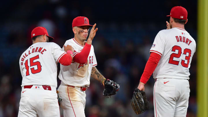 August 3, 2024; Anaheim, California, USA; Los Angeles Angels second base Luis Guillorme (15) shortstop Zach Neto (9) an dthird baseman Brandon Drury (23) celebrate the victory against the New York Mets at Angel Stadium. Mandatory Credit: Gary A. Vasquez-USA TODAY Sports