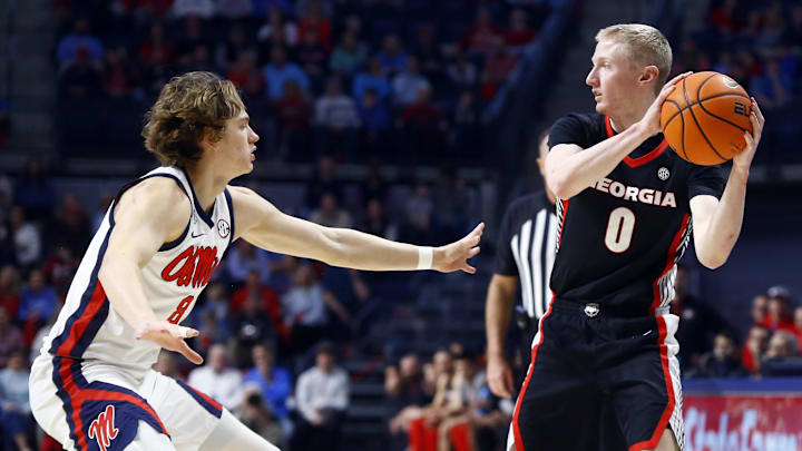 Jan 4, 2025; Oxford, Mississippi, USA; Georgia Bulldogs guard Blue Cain (0) handles the ball as Mississippi Rebels guard Eduardo Klafke (8) defends during the first half at The Sandy and John Black Pavilion at Ole Miss. Mandatory Credit: Petre Thomas-Imagn Images Jan 4, 2025; Oxford, Mississippi, USA; Georgia Bulldogs guard Blue Cain (0) handles the ball as Mississippi Rebels guard Eduardo Klafke (8) defends during the first half at The Sandy and John Black Pavilion at Ole Miss. Mandatory Credit: Petre Thomas-Imagn Images