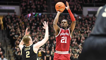 Jan 31, 2025; West Lafayette, Indiana, USA; Indiana Hoosiers forward Mackenzie Mgbako (21) makes a three-point basket over Purdue Boilermakers guard Fletcher Loyer (2) during the first half at Mackey Arena. Mandatory Credit: Robert Goddin-Imagn Images