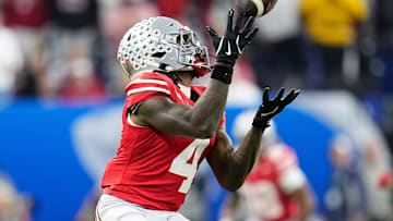Ohio State Buckeyes wide receiver Jeremiah Smith (4) catches a pass during the first half of the Big Ten Conference championship game against the Indiana Hoosiers at Lucas Oil Stadium in Indianapolis on Dec. 6, 2025.