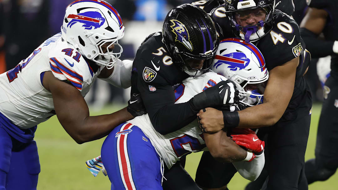 Sep 29, 2024; Baltimore, Maryland, USA; Buffalo Bills running back Ray Davis (22) is tackled by Baltimore Ravens linebacker Adisa Isaac (50) and Ravens linebacker Malik Harrison (40) at M&T Bank Stadium. Mandatory Credit: Geoff Burke-Imagn Images