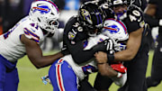 Sep 29, 2024; Baltimore, Maryland, USA; Buffalo Bills running back Ray Davis (22) is tackled by Baltimore Ravens linebacker Adisa Isaac (50) and Ravens linebacker Malik Harrison (40) at M&T Bank Stadium. Mandatory Credit: Geoff Burke-Imagn Images