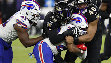 Sep 29, 2024; Baltimore, Maryland, USA; Buffalo Bills running back Ray Davis (22) is tackled by Baltimore Ravens linebacker Adisa Isaac (50) and Ravens linebacker Malik Harrison (40) at M&T Bank Stadium. Mandatory Credit: Geoff Burke-Imagn Images