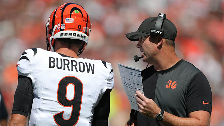 Cincinnati Bengals head coach Zac Taylor, right, has a word with quarterback Joe Burrow (9) during the first half of an NFL football game at Huntington Bank Field, Sept. 7, 2025, in Cleveland, Ohio.