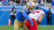 Nov 30, 2024; Pasadena, California, USA; UCLA Bruins linebacker Carson Schwesinger (49) Fresno State Bulldogs tight end Jake Tarwater (87) during the third quarter at Rose Bowl. Mandatory Credit: Robert Hanashiro-Imagn Images