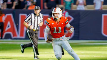 Nov 8, 2025; Miami Gardens, Florida, USA; Miami Hurricanes quarterback Carson Beck (11) rushes the ball against the Syracuse Orange during the first quarter at Hard Rock Stadium. Mandatory Credit: Jeff Romance-Imagn Images