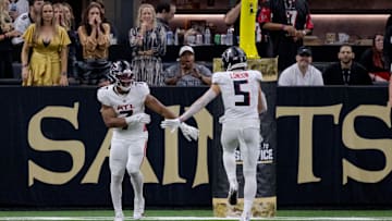 Nov 10, 2024; New Orleans, Louisiana, USA; Atlanta Falcons running back Bijan Robinson (7) celebrates a touchdown with Atlanta Falcons wide receiver Drake London (5) during the second half against the New Orleans Saints at Caesars Superdome. Mandatory Credit: Matthew Hinton-Imagn Images