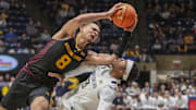 Arizona State Sun Devils forward Basheer Jihad (8) collides with West Virginia Mountaineers guard KJ Tenner (3) during the second half at WVU Coliseum.