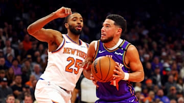Nov 20, 2024; Phoenix, Arizona, USA; Phoenix Suns guard Devin Booker (1) drives to the basket against New York Knicks forward Mikal Bridges (25) during the second quarter at Footprint Center. Mandatory Credit: Mark J. Rebilas-Imagn Images