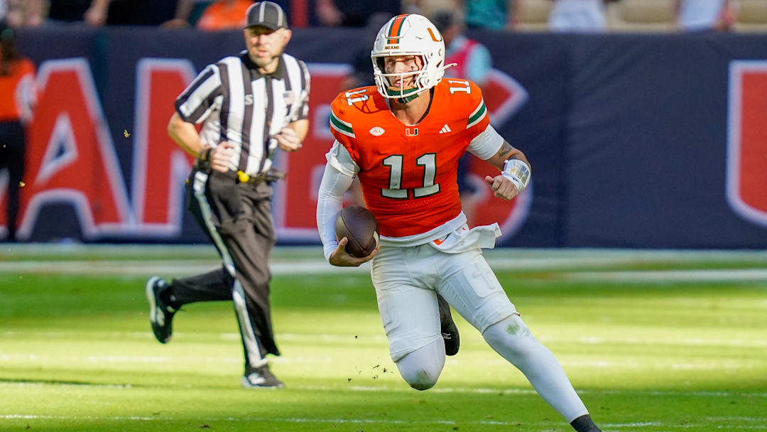 Nov 8, 2025; Miami Gardens, Florida, USA; Miami Hurricanes quarterback Carson Beck (11) rushes the ball against the Syracuse Orange during the first quarter at Hard Rock Stadium. Mandatory Credit: Jeff Romance-Imagn Images