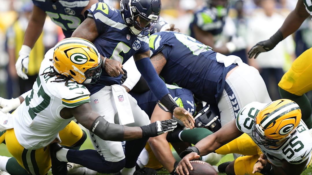 Aug 23, 2025; Green Bay, Wisconsin, USA; Green Bay Packers defensive end Kingsley Enagbare (55) recovers a fumble as Seattle Seahawks quarterback Jalen Milroe (6) is tackled by Green Bay Packers defensive end Brenton Cox Jr. (57) during the first half at Lambeau Field. 