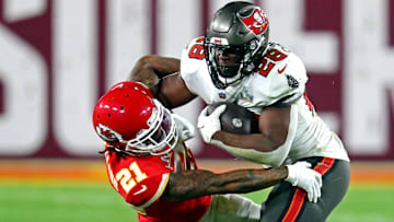 Feb 7, 2021; Tampa, FL, USA;  Tampa Bay Buccaneers running back Leonard Fournette (28) runs the all against Kansas City Chiefs cornerback Bashaud Breeland (21) during the third quarter in Super Bowl LV at Raymond James Stadium.  Mandatory Credit: Mark J. Rebilas-Imagn Images