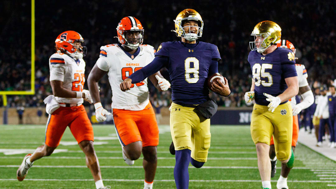 Notre Dame quarterback Kenny Minchey (8) runs the ball into the end zone for a touchdown in the second half of a NCAA football game against Syracuse at Notre Dame Stadium on Saturday, Nov. 22, 2025, in South Bend. Notre Dame quarterback Kenny Minchey (8) runs the ball into the end zone for a touchdown in the second half of a NCAA football game against Syracuse at Notre Dame Stadium on Saturday, Nov. 22, 2025, in South Bend.