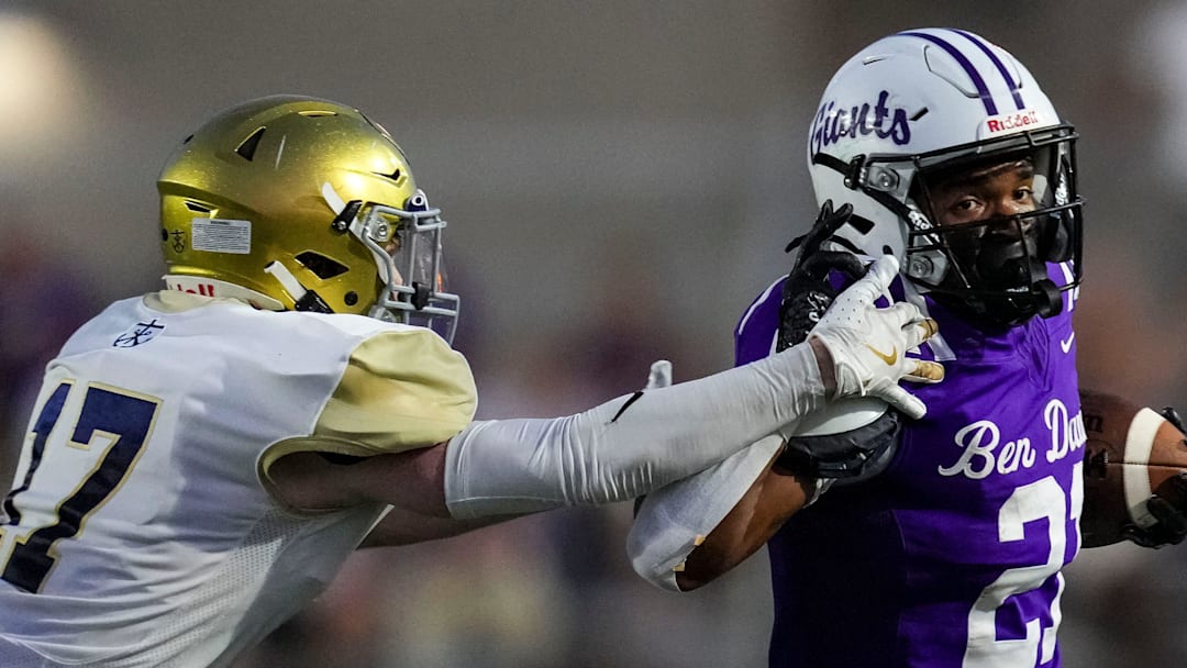 Ben Davis running back Alijah Price (21) brushes off Cathedral defender during their matchup in 2024.