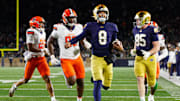 Notre Dame quarterback Kenny Minchey (8) runs the ball into the end zone for a touchdown in the second half of a NCAA football game against Syracuse at Notre Dame Stadium on Saturday, Nov. 22, 2025, in South Bend.