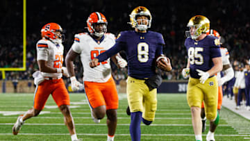 Notre Dame quarterback Kenny Minchey (8) runs the ball into the end zone for a touchdown in the second half of a NCAA football game against Syracuse at Notre Dame Stadium on Saturday, Nov. 22, 2025, in South Bend.