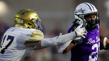 Ben Davis running back Alijah Price (21) brushes off Cathedral defender during their matchup in 2024.