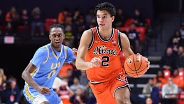 Nov 22, 2025; Champaign, Illinois, USA;  Illinois Fighting Illini guard Andrej Stojakovic (2) drives the ball past Long Island University Sharks guard Greg Gordon (2) during the first half at State Farm Center. Mandatory Credit: Ron Johnson-Imagn Images