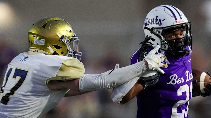 Ben Davis running back Alijah Price (21) brushes off Cathedral defender during their matchup in 2024.