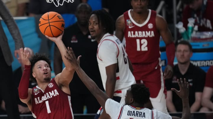 Alabama Crimson Tide guard Mark Sears (1) shoots against Connecticut Huskies guard Hassan Diarra (10) in the semifinals of the men's Final Four of the 2024 NCAA Tournament at State Farm Stadium.