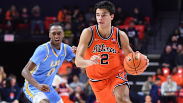 Nov 22, 2025; Champaign, Illinois, USA;  Illinois Fighting Illini guard Andrej Stojakovic (2) drives the ball past Long Island University Sharks guard Greg Gordon (2) during the first half at State Farm Center. Mandatory Credit: Ron Johnson-Imagn Images