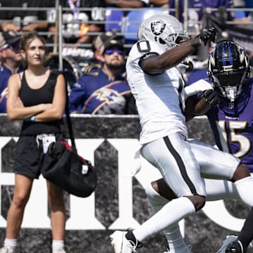 Sep 15, 2024; Baltimore, Maryland, USA;  h15] can’t secure a a pass as Las Vegas Raiders cornerback Jakorian Bennett (0) and  safety Tre'von Moehrig (7) defend during the first half at M&T Bank Stadium. Mandatory Credit: Tommy Gilligan-Imagn Images