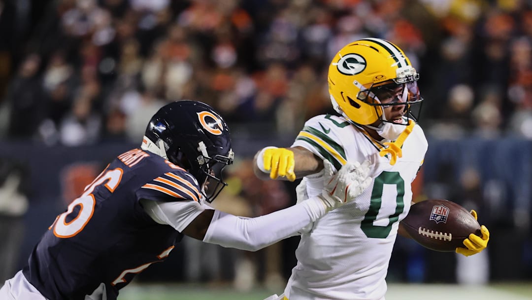 Dec 20, 2025; Chicago, Illinois, USA; Green Bay Packers wide receiver Matthew Golden (0) runs with the ball against Chicago Bears cornerback Nahshon Wright (26) during the first quarter at Soldier Field. Mandatory Credit: Mike Dinovo-Imagn Images