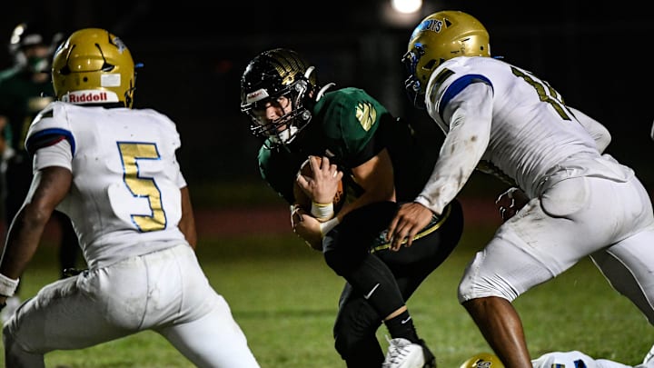 Ryan Boobar of Viera is brought down by Jeff Banks and Elijah Melendez of Osceola during their game Tuesday, October 15, 2024. The game was delayed from last Friday due to Hurricane Milton. Craig Bailey/FLORIDA TO2AY via USA TODAY NETWORK