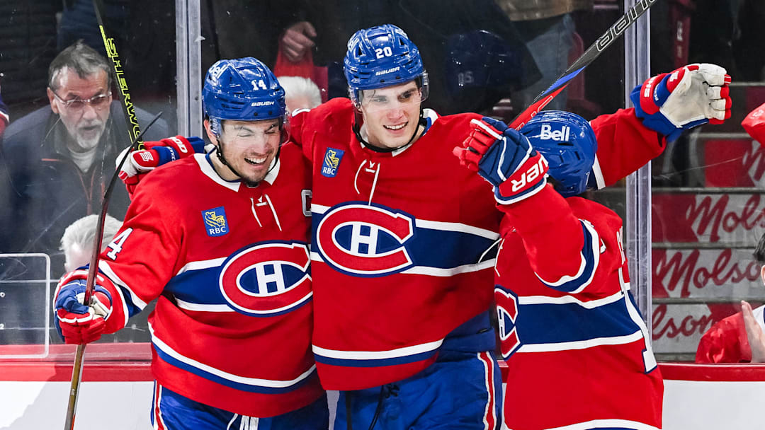 Mar 22, 2025; Montreal, Quebec, CAN; Montreal Canadiens left wing Juraj Slafkovsky (20) celebrates with center Nick Suzuki (14) and right wing Cole Caufield (13) his goal against the Colorado Avalanche in the third period at Bell Centre. Mandatory Credit: David Kirouac-Imagn Images