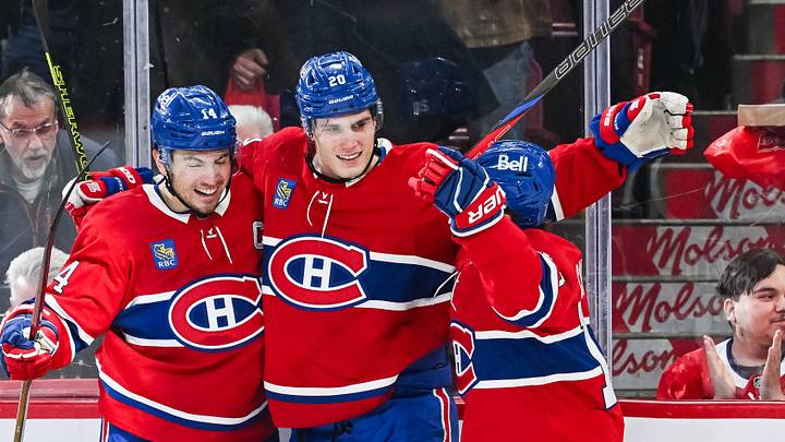 Mar 22, 2025; Montreal, Quebec, CAN; Montreal Canadiens left wing Juraj Slafkovsky (20) celebrates with center Nick Suzuki (14) and right wing Cole Caufield (13) his goal against the Colorado Avalanche in the third period at Bell Centre. Mandatory Credit: David Kirouac-Imagn Images