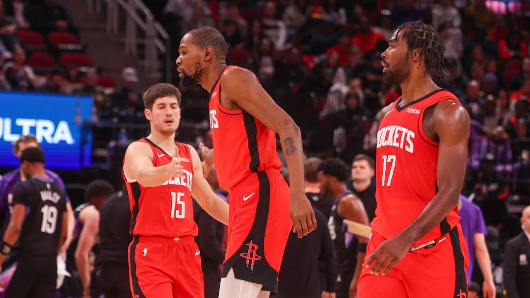 Feb 23, 2026; Houston, Texas, USA;  Houston Rockets guard Reed Sheppard (15) celebrates forward Kevin Durant (7) and forward Tari Eason (17) play against the Utah Jazz in the second quarter at Toyota Center. Mandatory Credit: Thomas Shea-Imagn Images