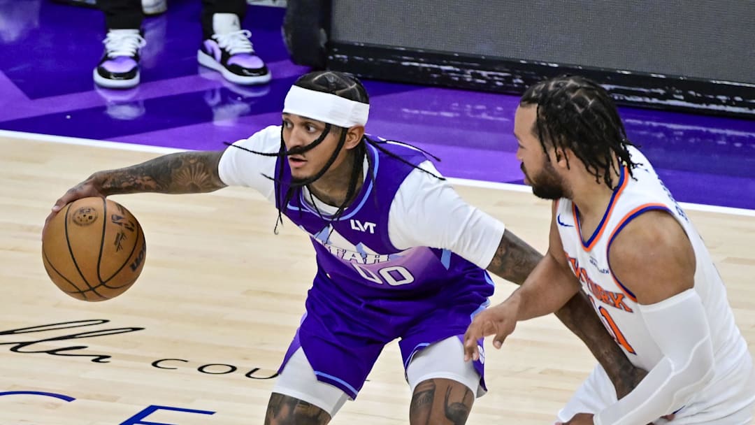Nov 23, 2024; Salt Lake City, Utah, USA; Utah Jazz guard Jordan Clarkson (00) dribbles the ball around New York Knicks guard Jalen Brunson (11) during the second half at the Delta Center. Mandatory Credit: Christopher Creveling-Imagn Images