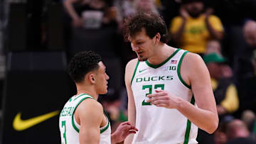 Two Oregon natives, Nate Bittle and Jackson Shelstad confer during Oregon's 72-59 win over Indiana at the Big Ten Tournament.