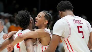 Houston Cougars guard L.J. Cryer (4) and guard Milos Uzan (7) celebrate their win against the Tennessee Volunteers following a game Sunday, March 30, 2025, during the Elite Eight round of the NCAA March Madness tournament at Lucas Oil Stadium in Indianapolis. Houston defeated Tennessee 69-50.