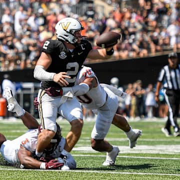 Aug 31, 2024; Vanderbilt quarterback Diego Pavia (2) fumbles the ball after being hit by Virginia Tech linebacker Caleb Woodson (20).