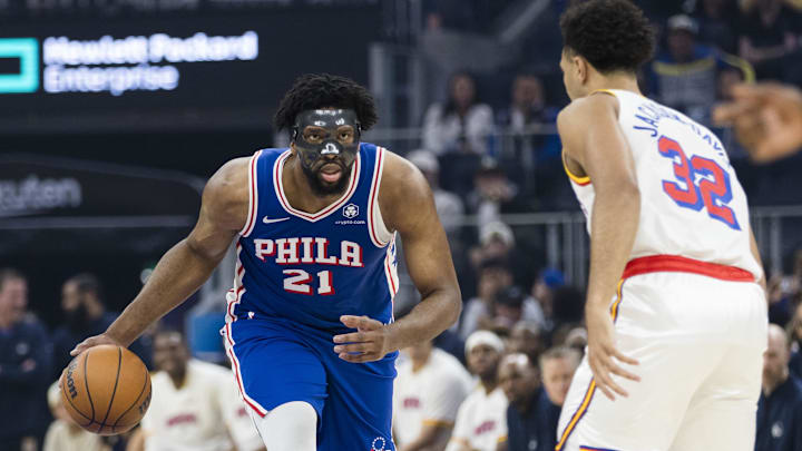 Philadelphia 76ers center Joel Embiid (21) drives past Golden State Warriors forward Trayce Jackson-Davis (32) during the first quarter at Chase Center. Philadelphia 76ers center Joel Embiid (21) drives past Golden State Warriors forward Trayce Jackson-Davis (32) during the first quarter at Chase Center.