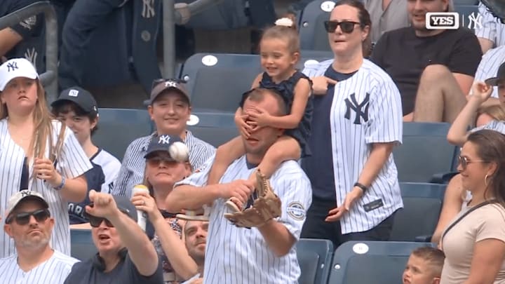 Yankees fan makes a catch as his eyes are covered