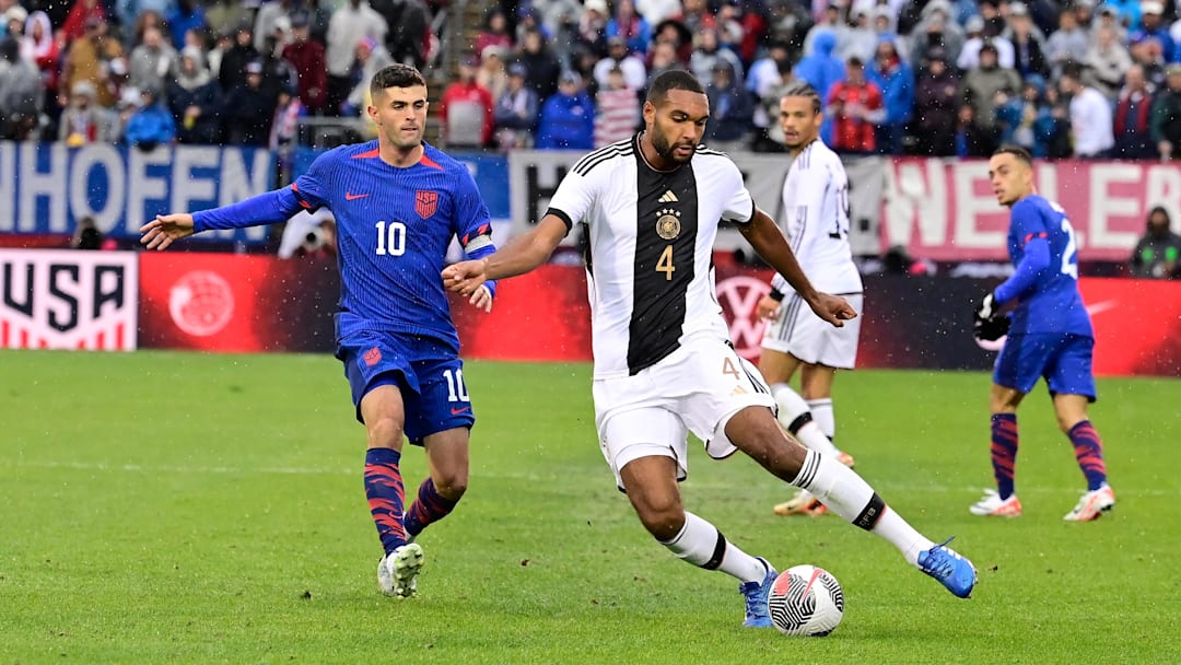 Oct 14, 2023; East Hartford, Connecticut, USA; Germany defender Jonathan Tah (4) passes the ball in front of United States forward Christian Pulisic (10) during the second half at Pratt & Whitney Stadium. Mandatory Credit: Eric Canha-Imagn Images