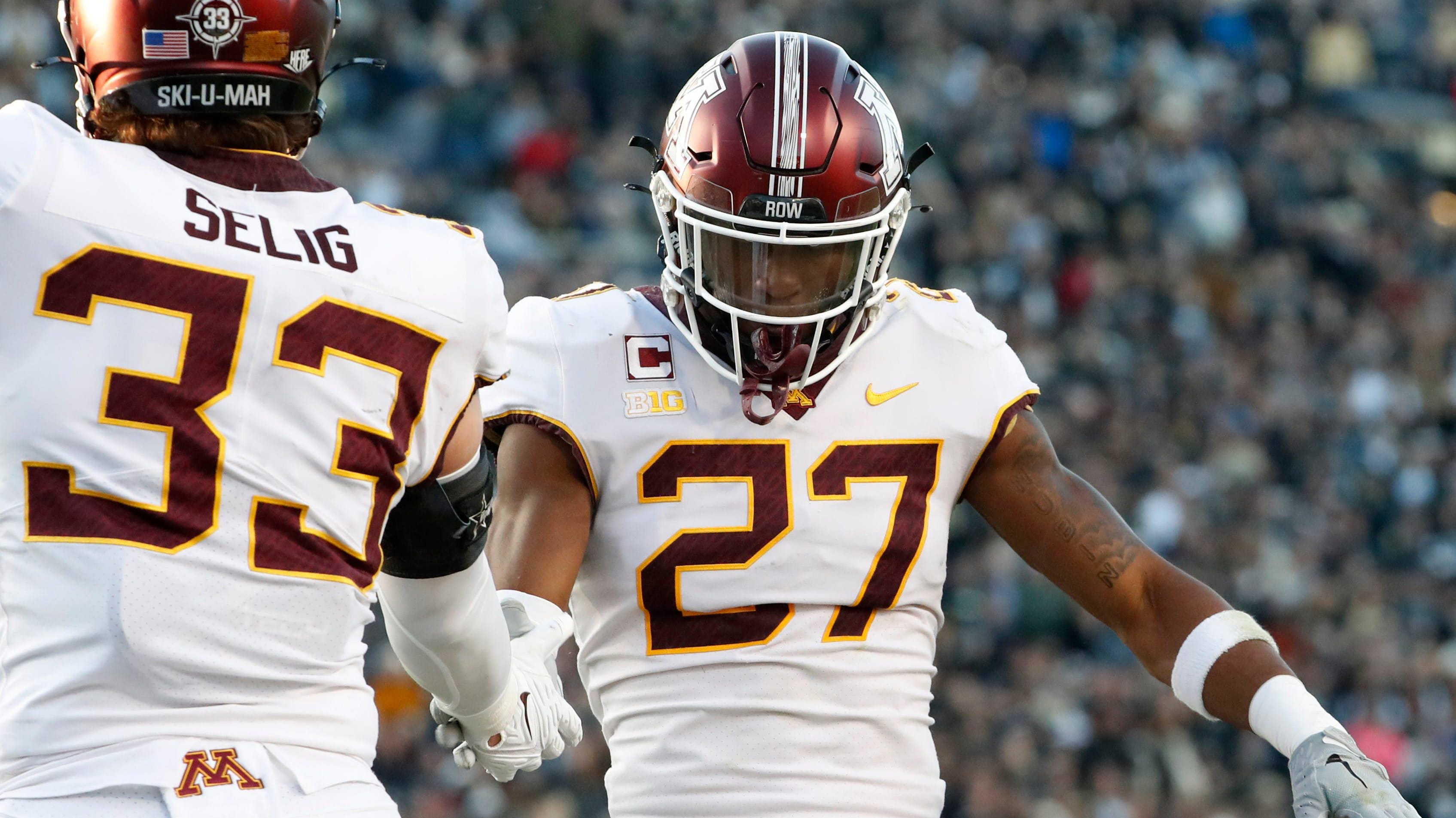 Minnesota Golden Gophers linebacker Ryan Selig (33) and Minnesota Golden Gophers defensive back Tyler Nubin celebrate.