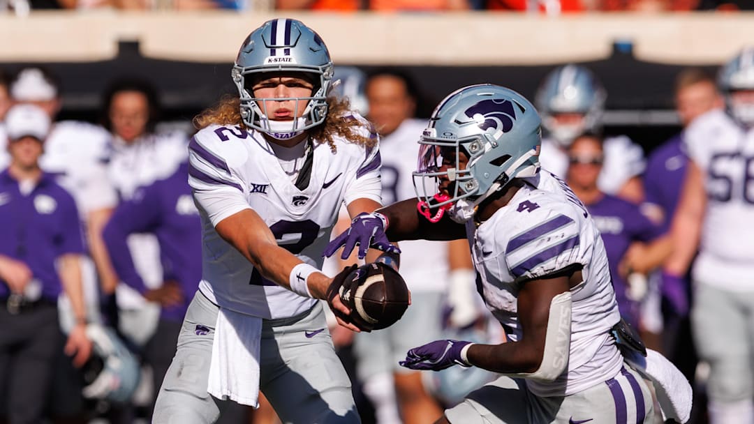 Nov 15, 2025; Stillwater, Oklahoma, USA; Kansas State Wildcats quarterback Avery Johnson (2) hands off to Kansas State Wildcats running back Joe Jackson (4) during the second half against the Oklahoma State Cowboys at Boone Pickens Stadium. Mandatory Credit: William Purnell-Imagn Images