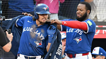 Sep 28, 2025; Toronto, Ontario, CAN;  Toronto Blue Jays first baseman Vladimir Guerrero Jr. (27) drapes the team home run jacket on third baseman Addison Barger (47) after he hit a two-run home run against the Tampa Bay Rays in the seventh inning at Rogers Centre. Mandatory Credit: Dan Hamilton-Imagn Images