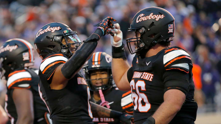 Oct 6, 2023; Stillwater, Oklahoma, USA; Oklahoma State player Ollie Gordon II (0) celebrates his touchdown with Oklahoma State's Joe Michalski (66) in the first half of the college football game between the Oklahoma State University Cowboys and the Kansas State Wildcats at Boone Pickens Stadium. Mandatory Credit: Sarah Phipps-USA TODAY Sports