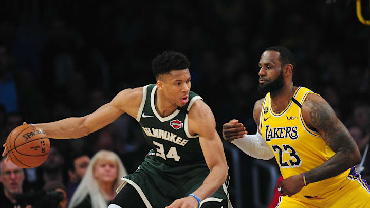 March 6, 2020; Los Angeles, California, USA; Milwaukee Bucks forward Giannis Antetokounmpo (34) controls the ball against Los Angeles Lakers forward LeBron James (23) during the first half at Staples Center. Mandatory Credit: Gary A. Vasquez-Imagn Images
